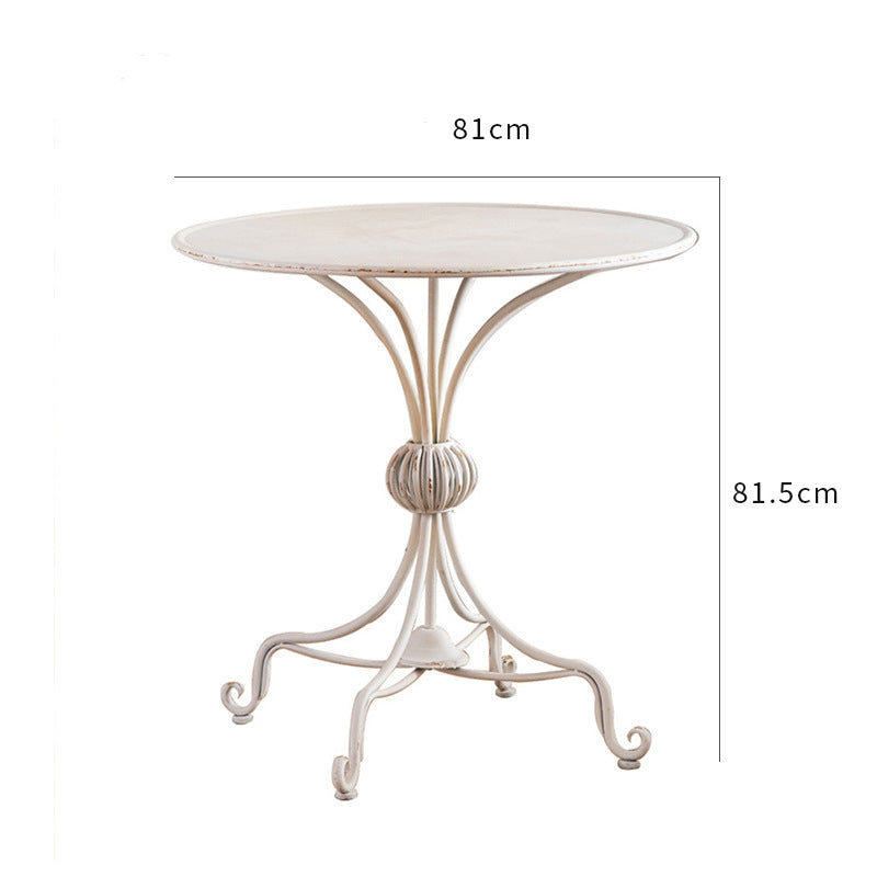 Introducing the Unwind in Style: The White American Balcony Table by Furnishaus. This vintage-style, cream-finished metal table (81 cm diameter, 81.5 cm height) is perfect for intimate white balcony decor with its decorative central support. Available now at ShopFurnishaus.com.