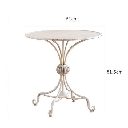 Introducing the Unwind in Style: The White American Balcony Table by Furnishaus. This vintage-style, cream-finished metal table (81 cm diameter, 81.5 cm height) is perfect for intimate white balcony decor with its decorative central support. Available now at ShopFurnishaus.com.